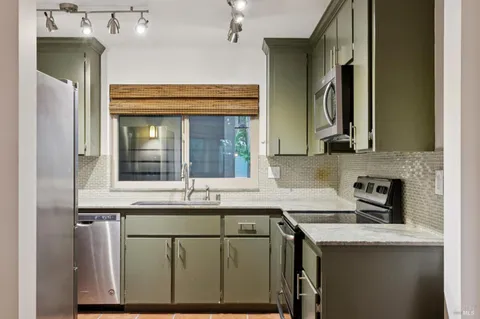 a kitchen with stainless steel appliances granite countertop a sink and cabinets