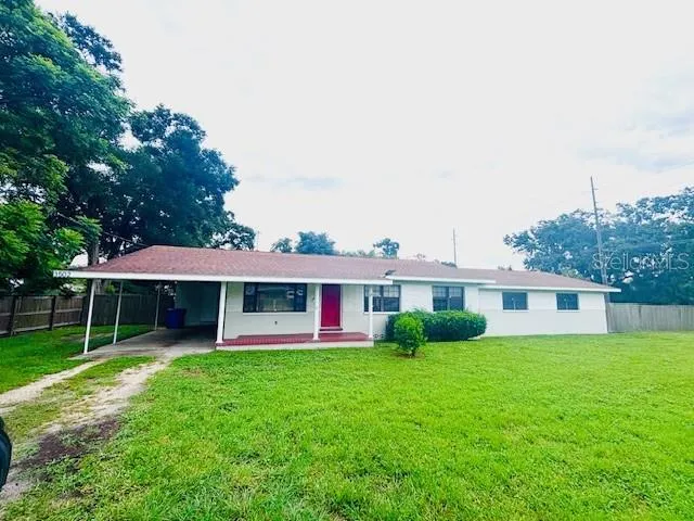 a view of a house with a yard and sitting area