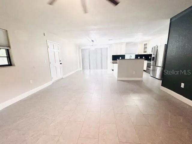 a view of a kitchen with a sink and cabinets