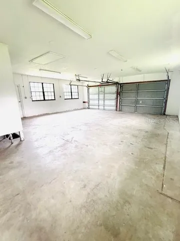 a view of an empty room with kitchen