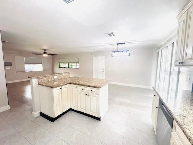 a bathroom with a granite countertop sink mirror and a bathtub
