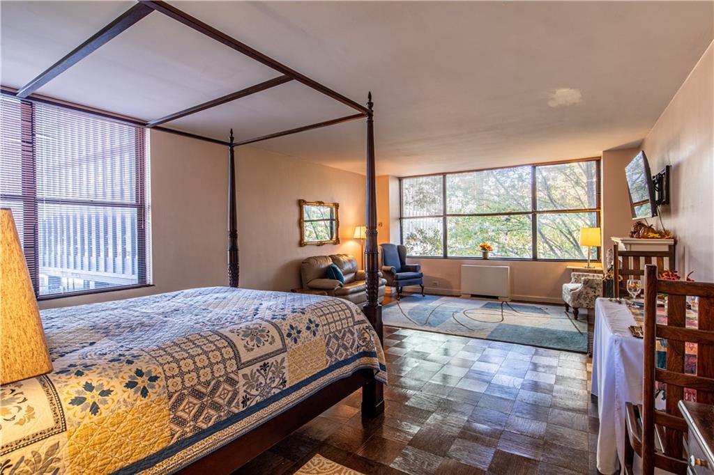 112 Washington Place, Unit 2F Pittsburgh, PA 15219 - Photo 11 of 30 a bedroom with a large bed and a window