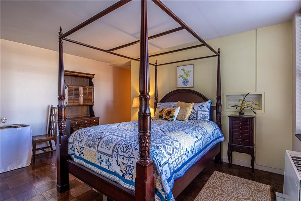 112 Washington Place, Unit 2F Pittsburgh, PA 15219 - Photo 12 of 30 a bedroom with a bed and wooden floor