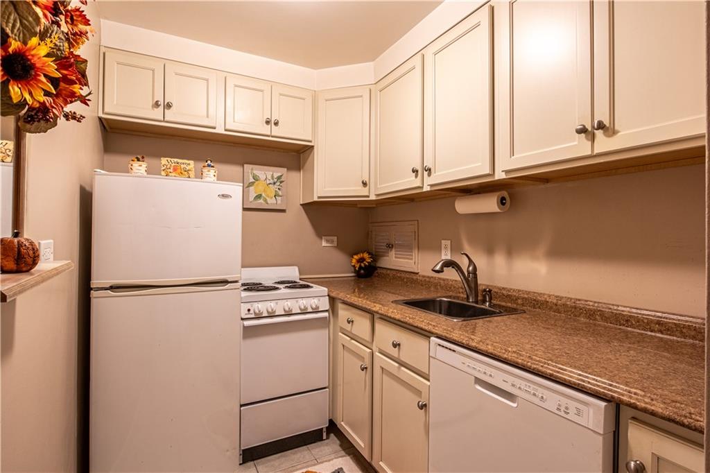 112 Washington Place, Unit 2F Pittsburgh, PA 15219 - Photo 15 of 30 a kitchen with a refrigerator and cabinets