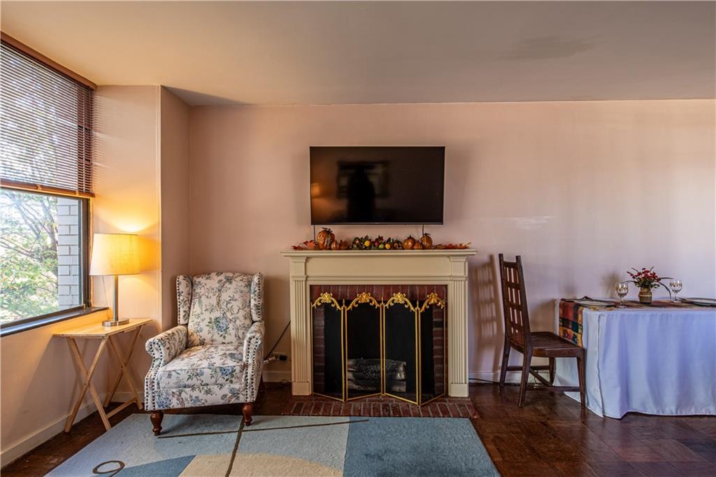 112 Washington Place, Unit 2F Pittsburgh, PA 15219 - Photo 8 of 30 a living room with furniture and a fireplace
