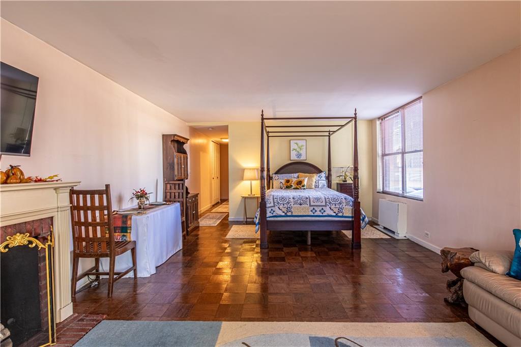 112 Washington Place, Unit 2F Pittsburgh, PA 15219 - Photo 10 of 30 a bedroom with furniture and a wooden floor