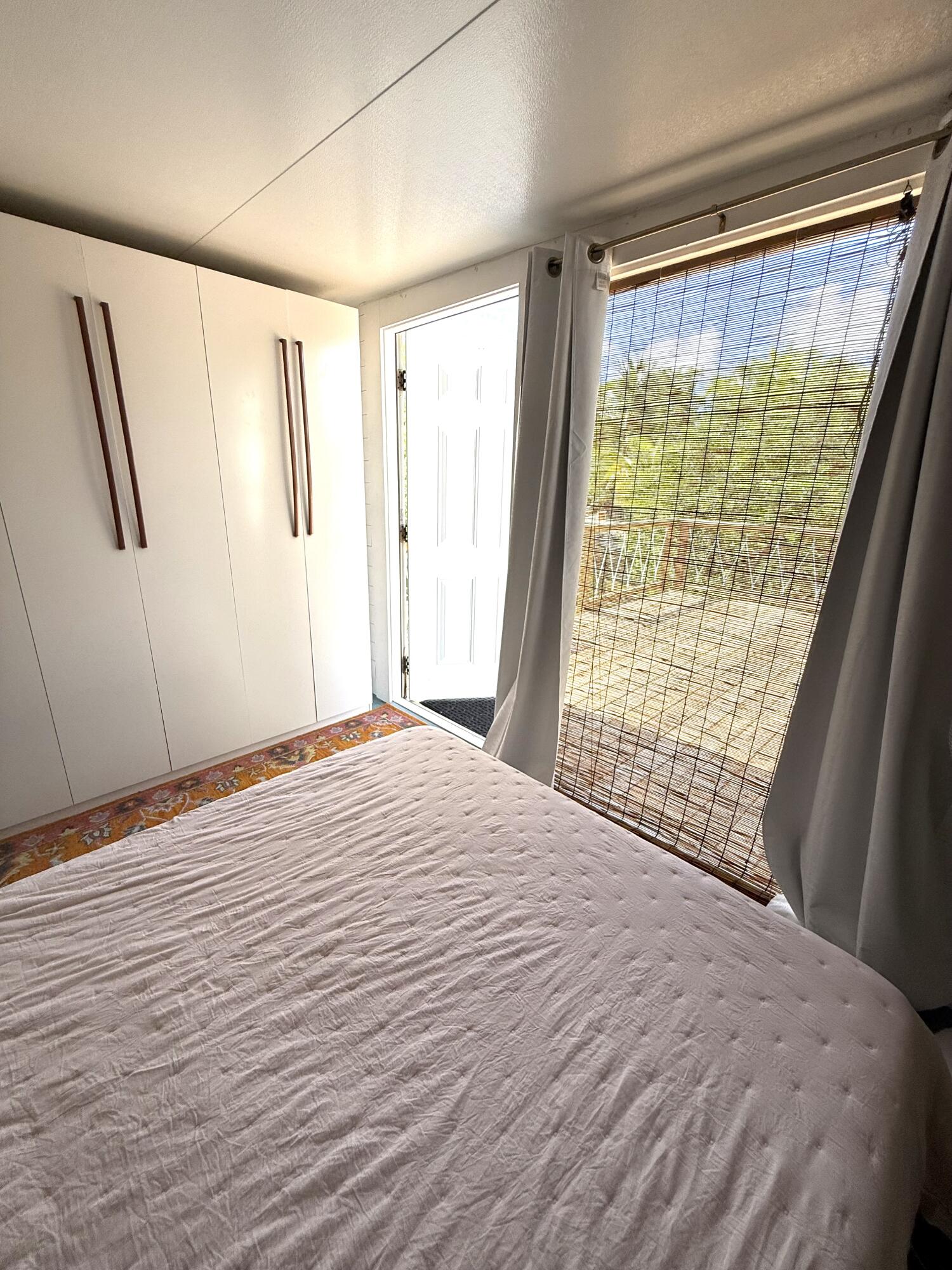 27960 Porgie Path Summerland Key, FL 33042 - Photo 17 of 30 a bedroom with a bed and a large window