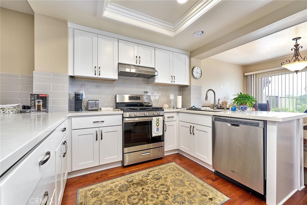 9 La Quinta Irvine, CA 92612 - Photo 13 of 39 a kitchen with white cabinets and white appliances