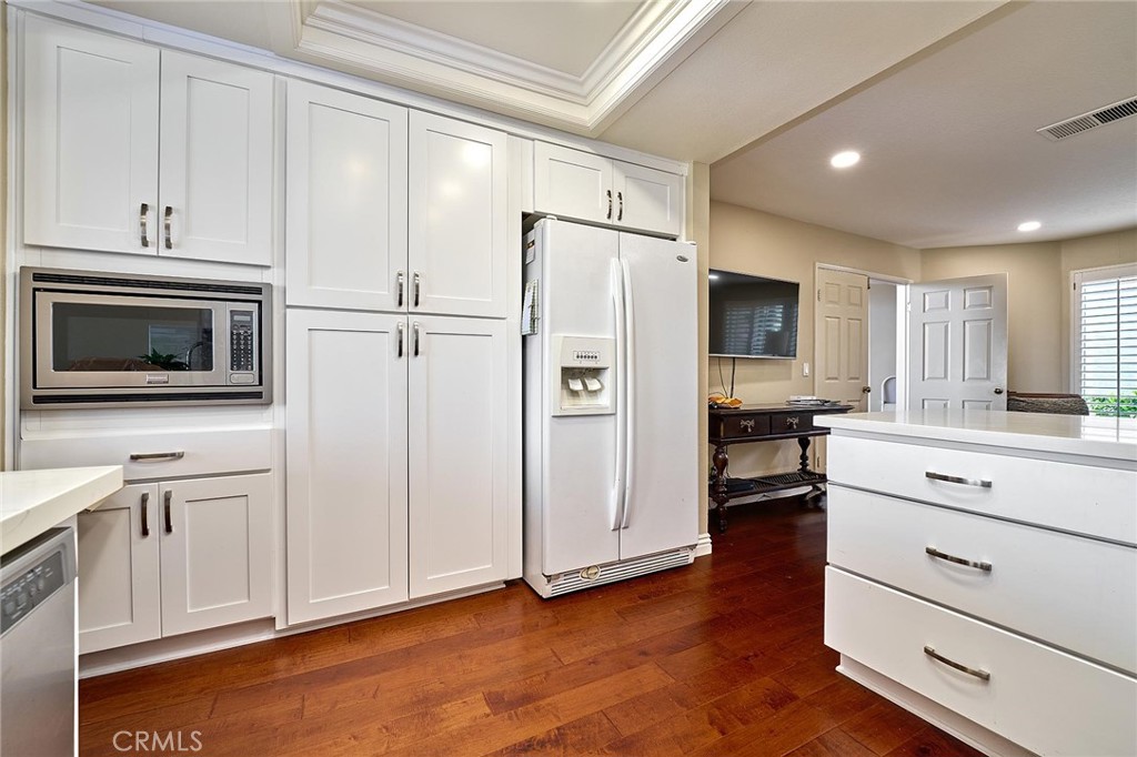 9 La Quinta Irvine, CA 92612 - Photo 15 of 39 a kitchen with stainless steel appliances white cabinets and a refrigerator