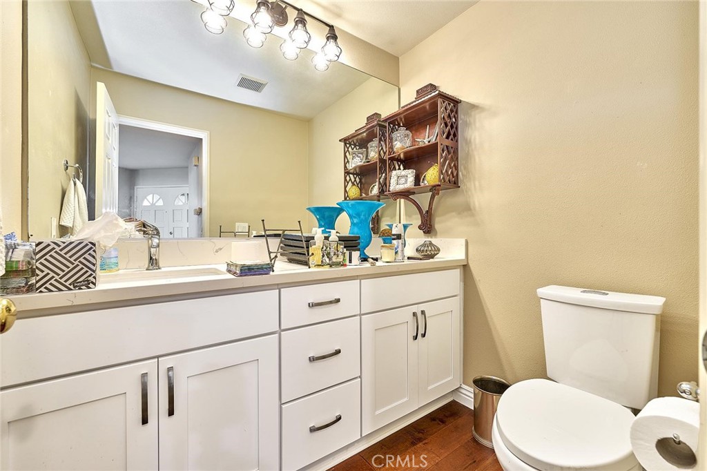 9 La Quinta Irvine, CA 92612 - Photo 17 of 39 a bathroom with a toilet a sink and mirror