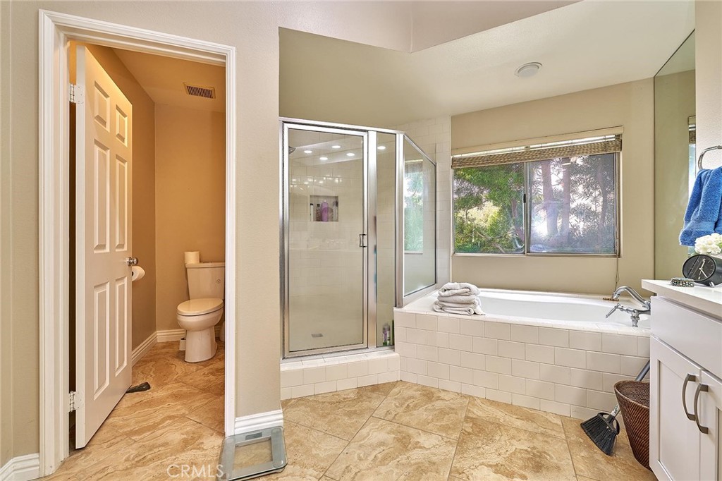 9 La Quinta Irvine, CA 92612 - Photo 22 of 39 a spacious bathroom with a tub shower and a sink