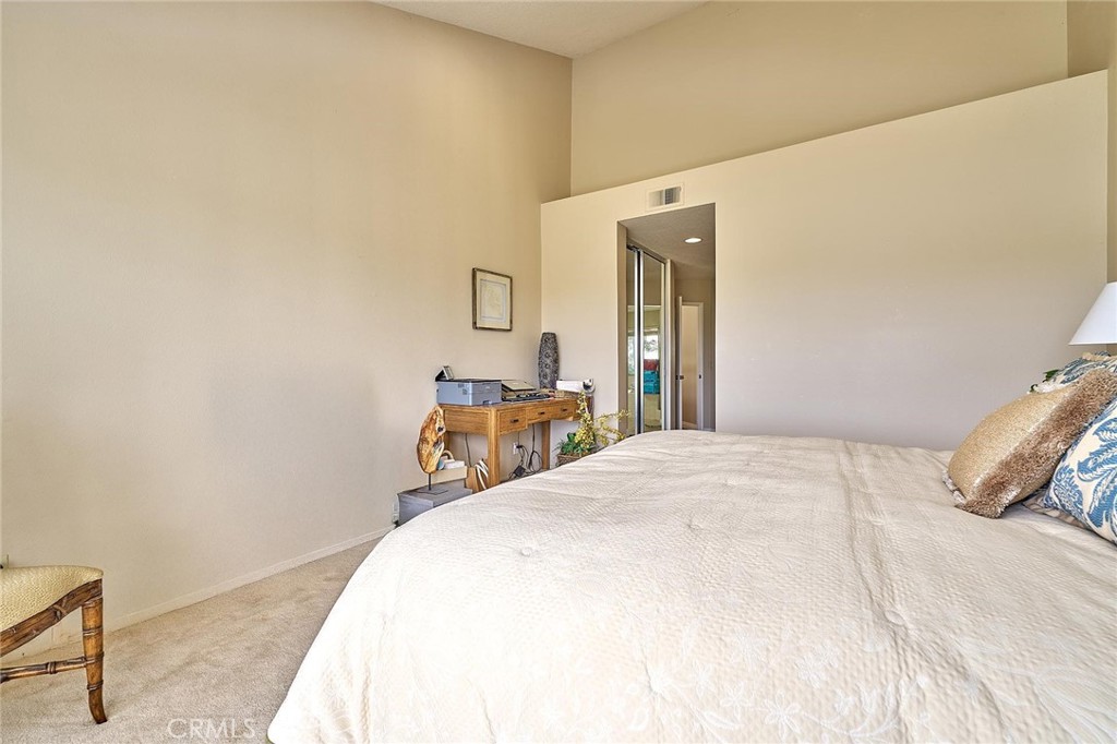 9 La Quinta Irvine, CA 92612 - Photo 23 of 39 a bedroom with a bed and a table