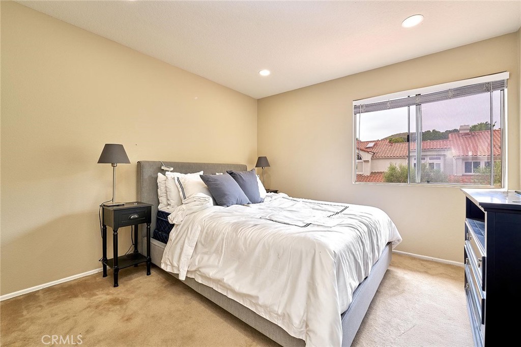 9 La Quinta Irvine, CA 92612 - Photo 24 of 39 a large bed sitting in a bedroom next to a window