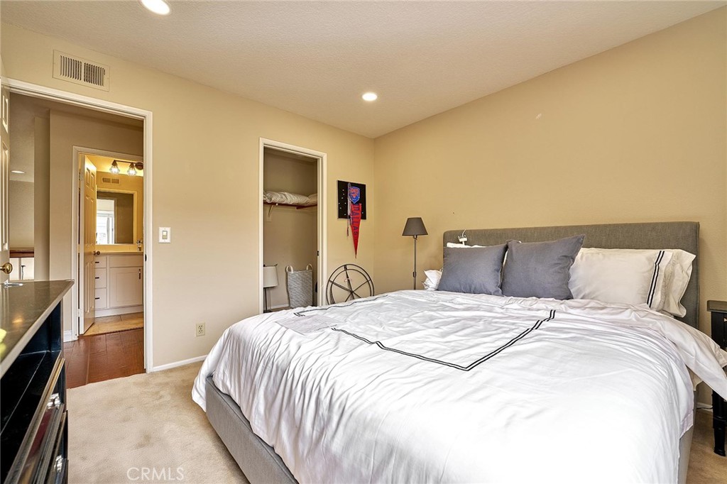 9 La Quinta Irvine, CA 92612 - Photo 25 of 39 a bedroom with a large bed and wooden floor