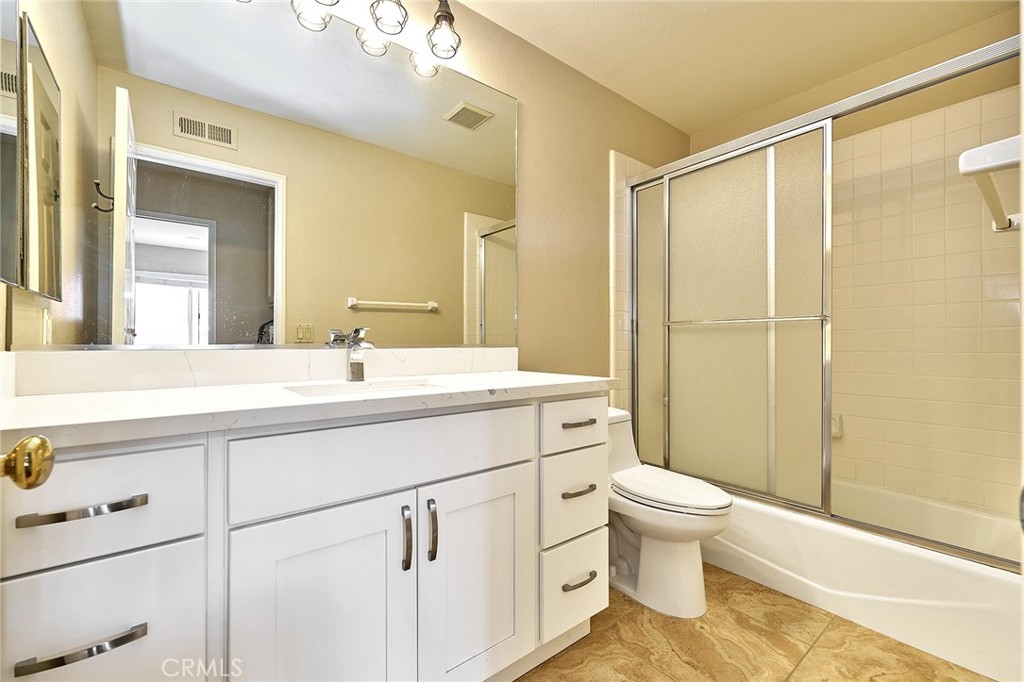 9 La Quinta Irvine, CA 92612 - Photo 28 of 39 a bathroom with a sink a toilet a mirror and shower