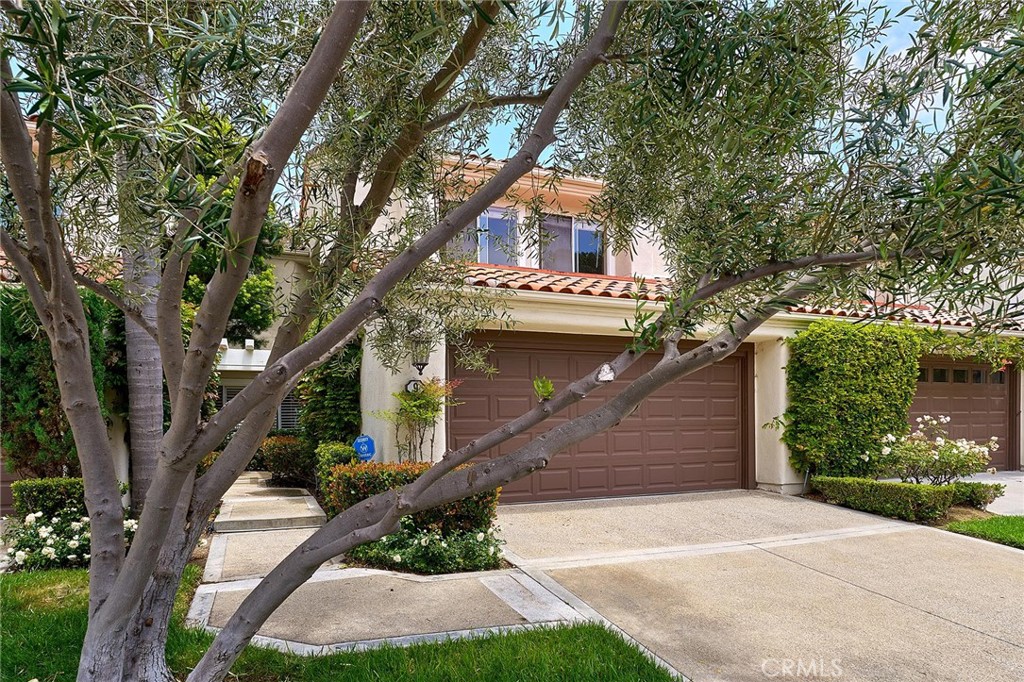 9 La Quinta Irvine, CA 92612 - Photo 38 of 39 a front view of a house with a yard garage and outdoor seating