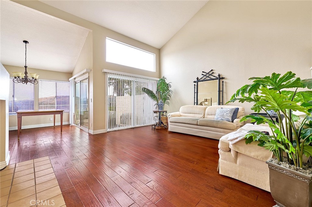 9 La Quinta Irvine, CA 92612 - Photo 6 of 39 a living room with furniture and a large window with wooden floor