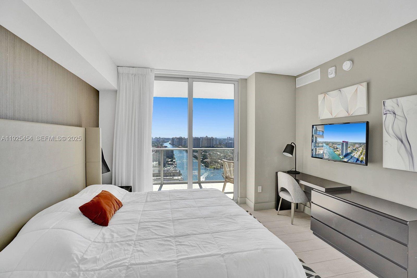 4010 South Ocean Drive, Unit R1108 Hollywood, FL 33019 - Photo 15 of 30 a bedroom with a bed and a large window