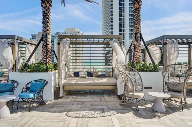 a bedroom with two beds and a large window with the outer view