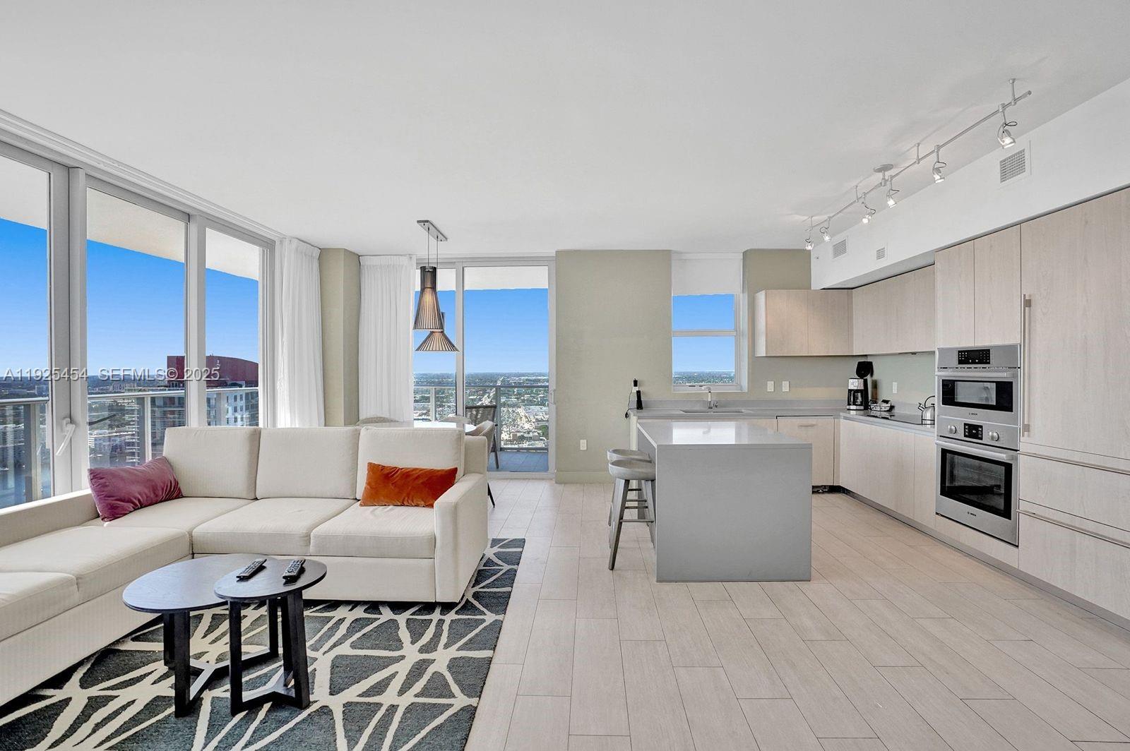 4010 South Ocean Drive, Unit R1108 Hollywood, FL 33019 - Photo 28 of 30 a living room with furniture and a kitchen area