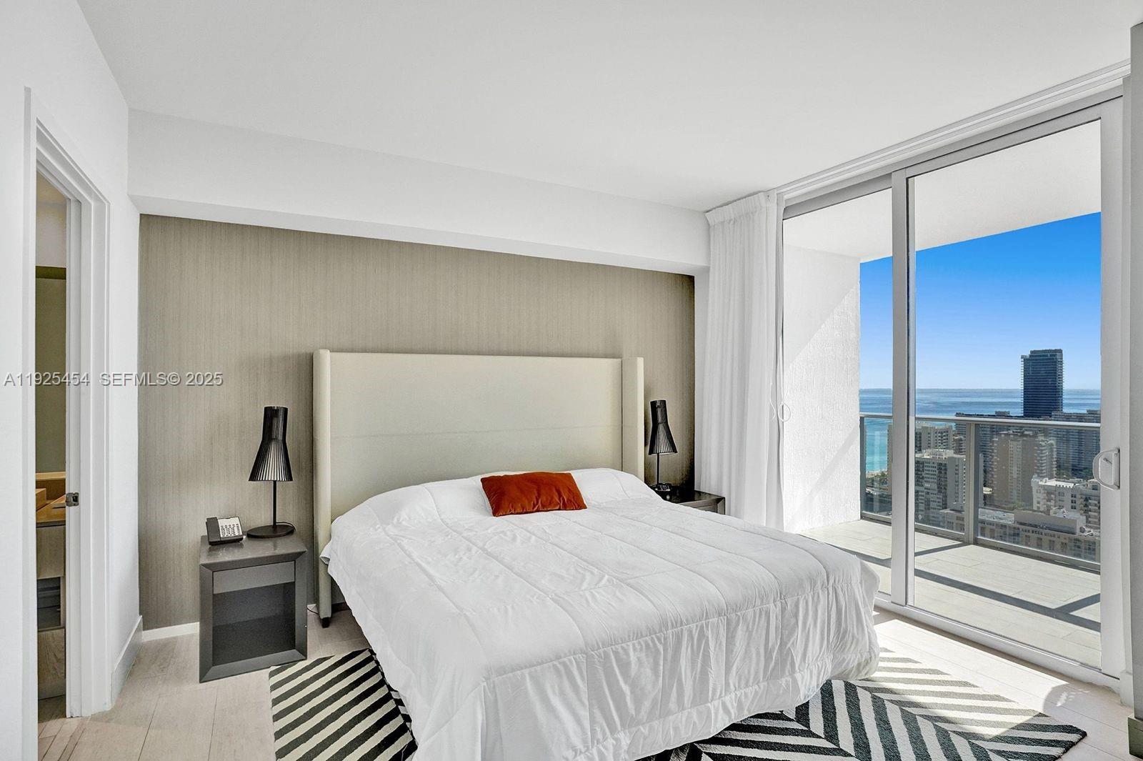 4010 South Ocean Drive, Unit R1108 Hollywood, FL 33019 - Photo 4 of 30 a bedroom with a bed and window