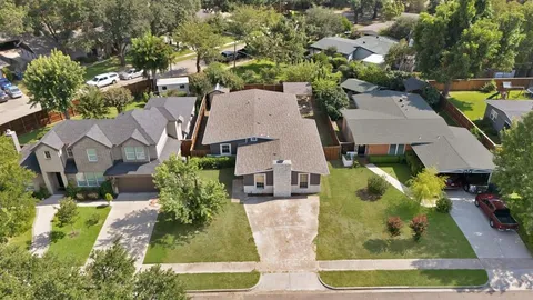 an aerial view of a house with a swimming pool