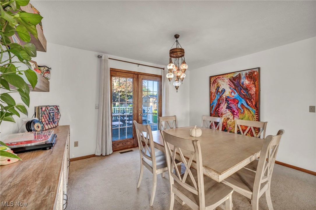 300 Decourcey Rittman, OH 44270 - Photo 11 of 48 Dining room with a chandelier and french doors to the back porch