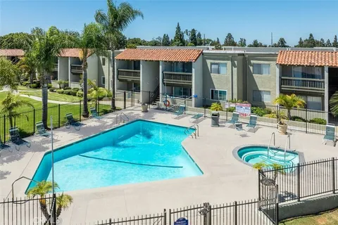 a view of a house with swimming pool and porch with furniture