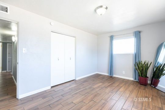240 West Graaf Avenue Ridgecrest, CA 93555 - Photo 17 of 28 a view of a room with wooden floor and potted plant