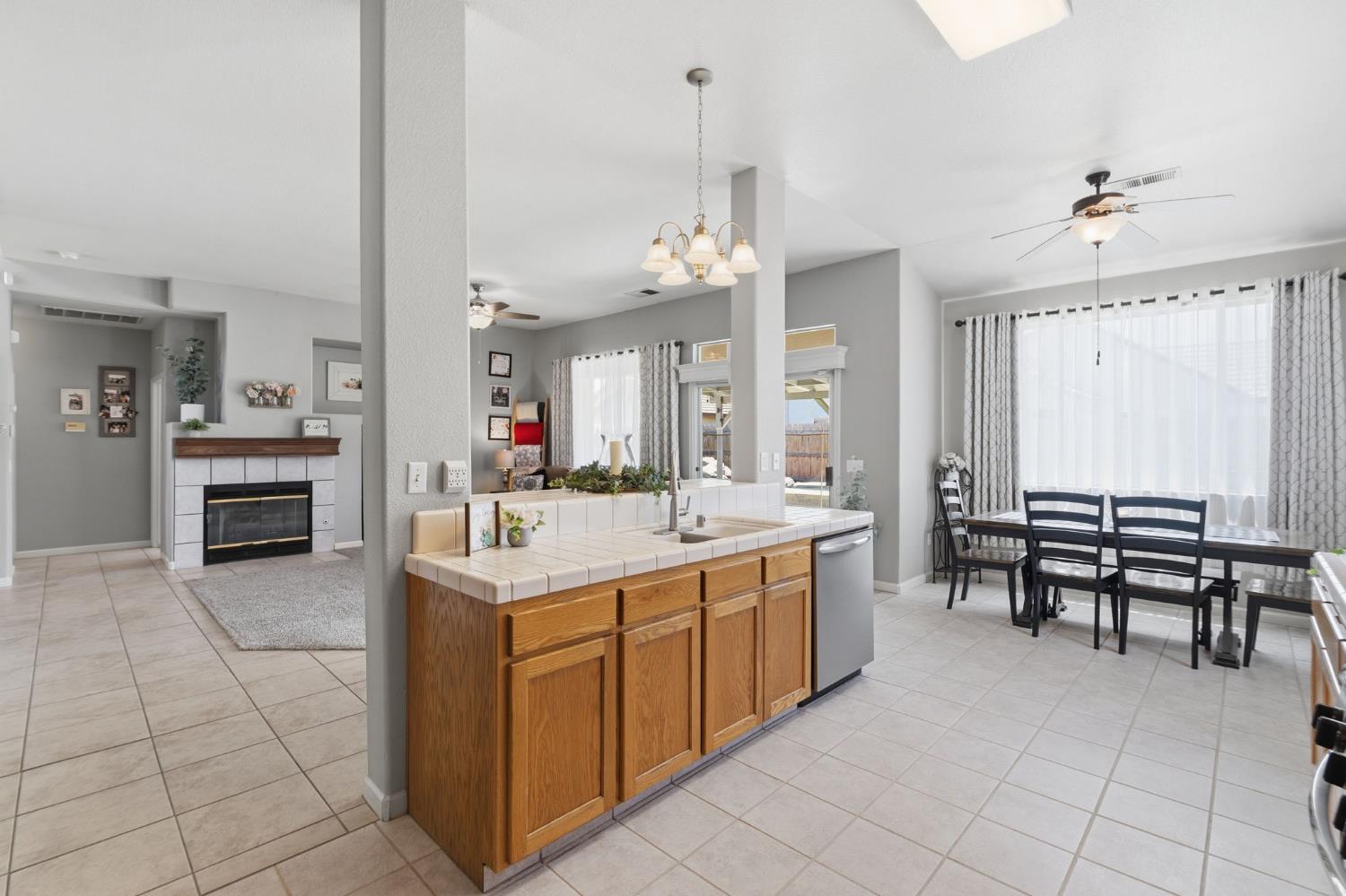 1757 Homestead Way Lemoore, CA 93245 - Photo 12 of 35 a kitchen with kitchen island granite countertop a sink counter and chairs