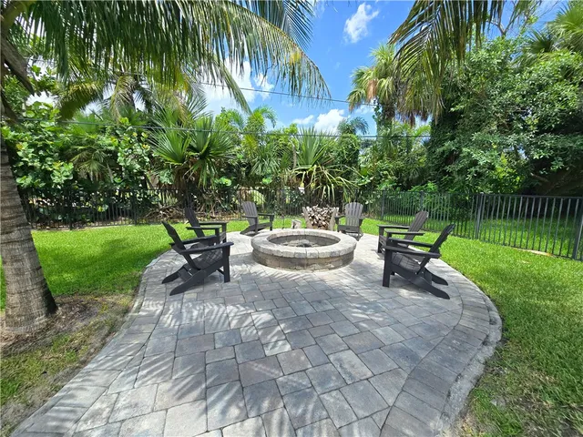 a view of a backyard with sitting area