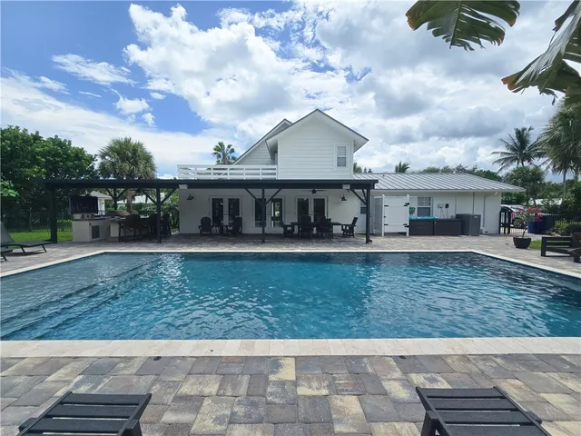 a view of house with swimming pool