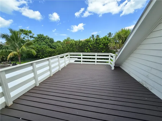 a view of deck with seating area and trees