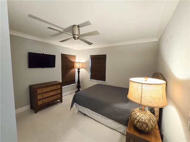 a bedroom with a bed and a lamp on desk