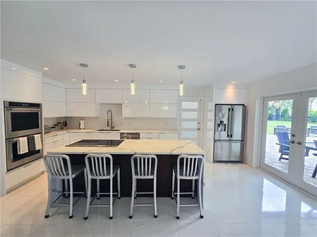 a large kitchen with a table and chairs