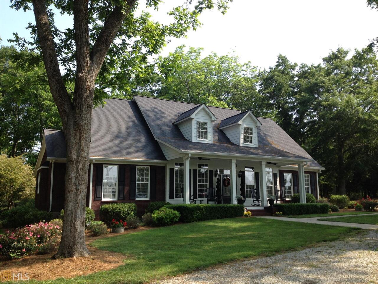 3264 Moina Michael Road Good Hope, GA 30641 - Photo 1 of 1 front view of a brick house with a yard