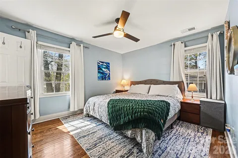 a bedroom with a large bed and a window