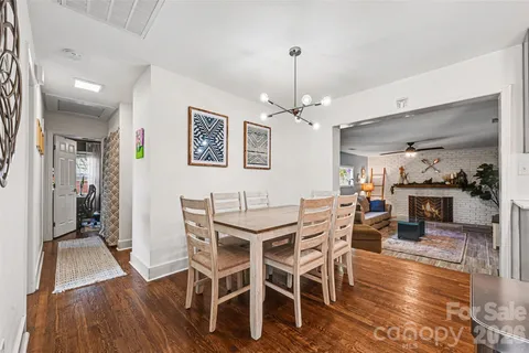 a view of a dining room with furniture wooden floor and chandelier