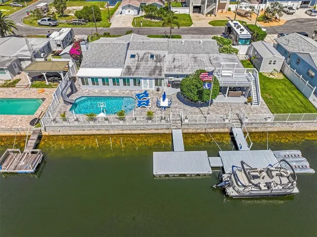 a view of a house with swimming pool and sitting area
