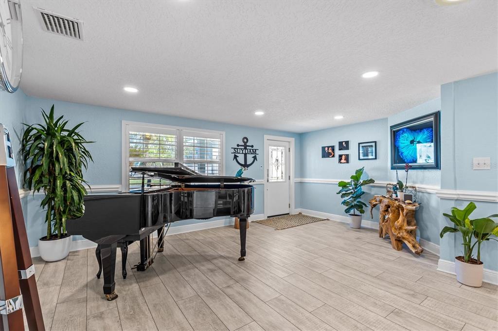 4387 6th Isle Drive Hernando Beach, FL 34607 - Photo 11 of 89 a living room with furniture and a potted plant