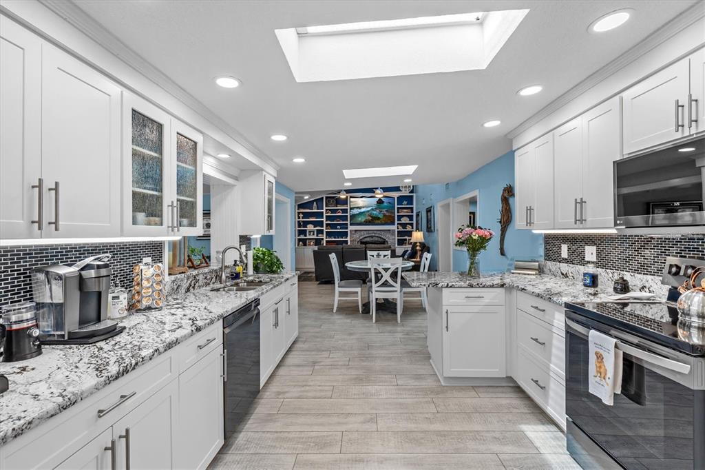 4387 6th Isle Drive Hernando Beach, FL 34607 - Photo 21 of 98 a kitchen with lots of counter top space a sink appliances and cabinets