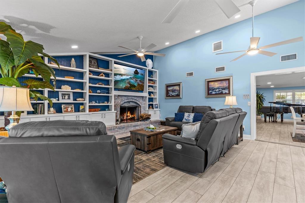 4387 6th Isle Drive Hernando Beach, FL 34607 - Photo 23 of 98 a living room with furniture and a fireplace