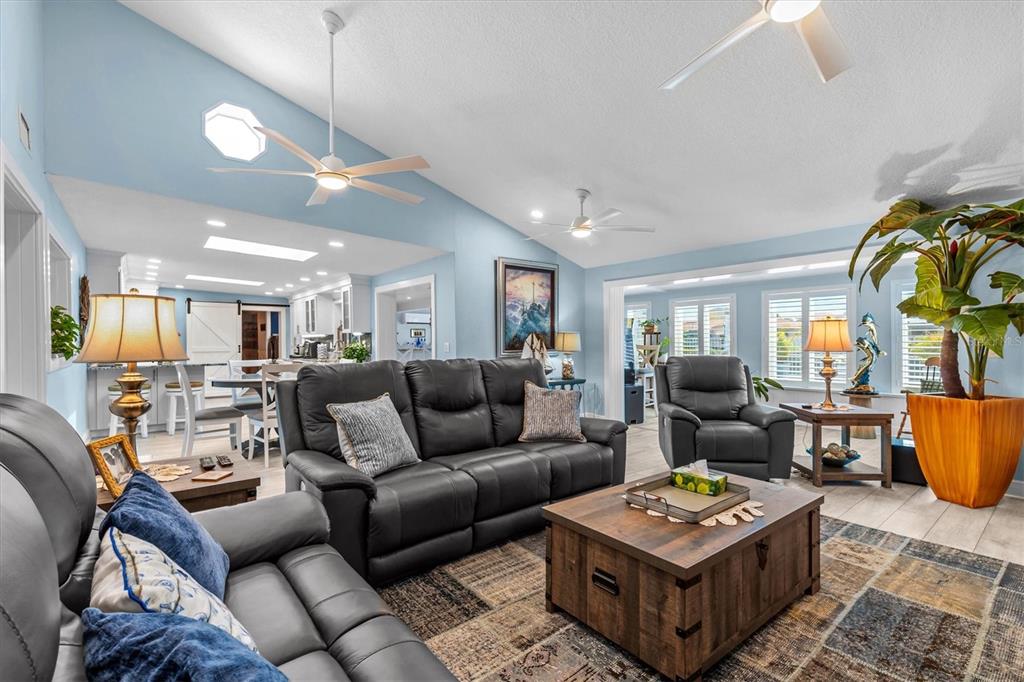 4387 6th Isle Drive Hernando Beach, FL 34607 - Photo 27 of 89 a living room with furniture a rug and a chandelier