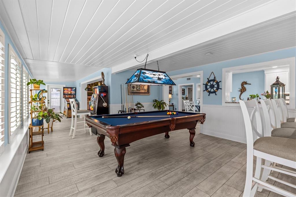 4387 6th Isle Drive Hernando Beach, FL 34607 - Photo 30 of 89 a living room with furniture a table and wooden floor