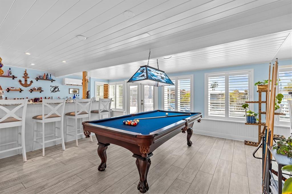 4387 6th Isle Drive Hernando Beach, FL 34607 - Photo 32 of 89 a room with furniture pool table wooden floor and windows