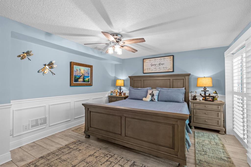 4387 6th Isle Drive Hernando Beach, FL 34607 - Photo 39 of 98 a bedroom with a bed and a chandelier