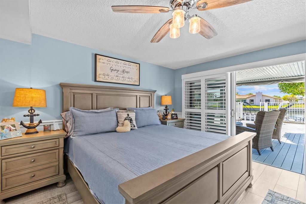 4387 6th Isle Drive Hernando Beach, FL 34607 - Photo 40 of 98 a bedroom with a bed and a chandelier