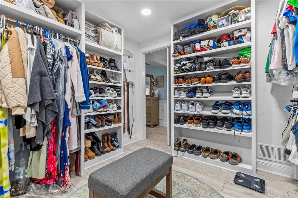 4387 6th Isle Drive Hernando Beach, FL 34607 - Photo 49 of 98 a view of walk in closet with clothes and shoes