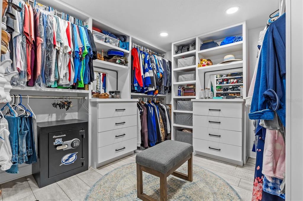 4387 6th Isle Drive Hernando Beach, FL 34607 - Photo 49 of 89 a view of walk in closet with clothes and shoes
