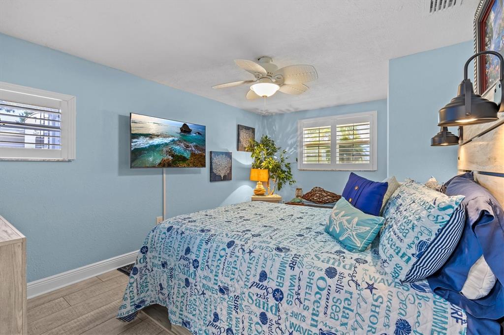 4387 6th Isle Drive Hernando Beach, FL 34607 - Photo 50 of 98 a bedroom with a bed and a flat screen tv